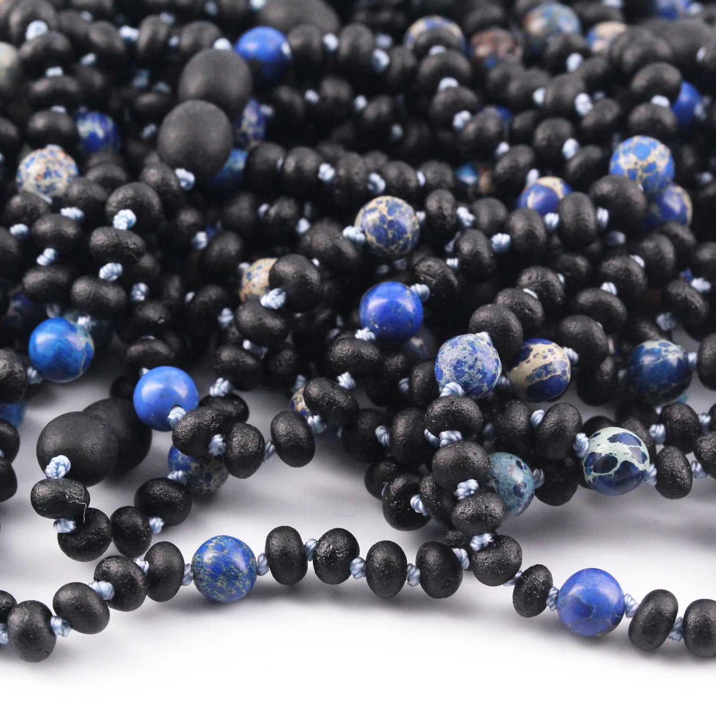 KALUNG BAYI AMBER DENGAN DEEP BLUE IMPERIAL JASPER. LE572
